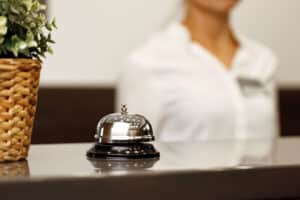 Hotel service bell on front desk counter close up